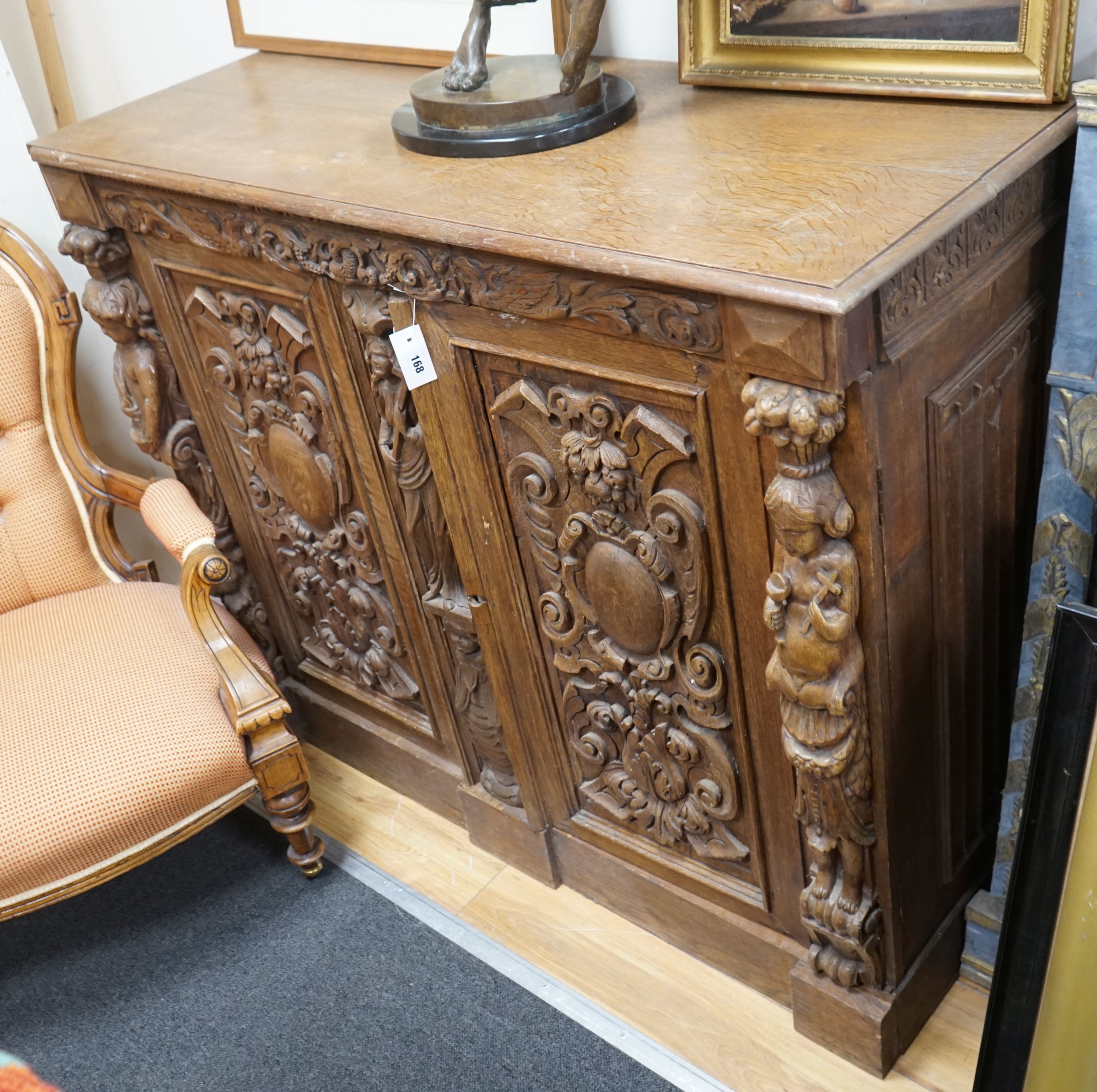 A late 19th / early 20th century Flemish carved oak cabinet section with drawer and pigeon hole interior, width 130cm, depth 52cm, height 107cm